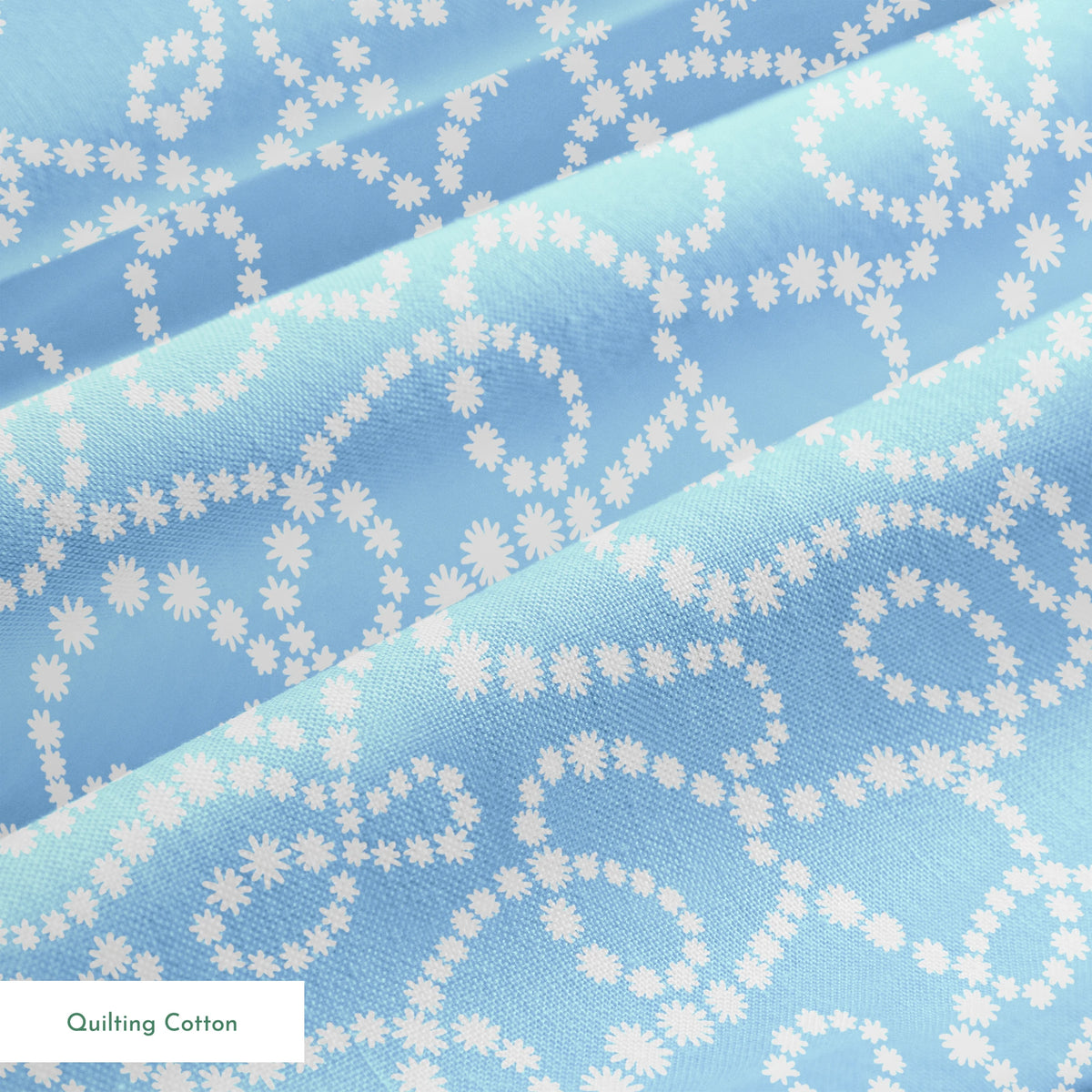 Pale blue background with white dotted swirling pattern resembling strings of pearls or bubbles in abstract curves springs quiltingcotton texture