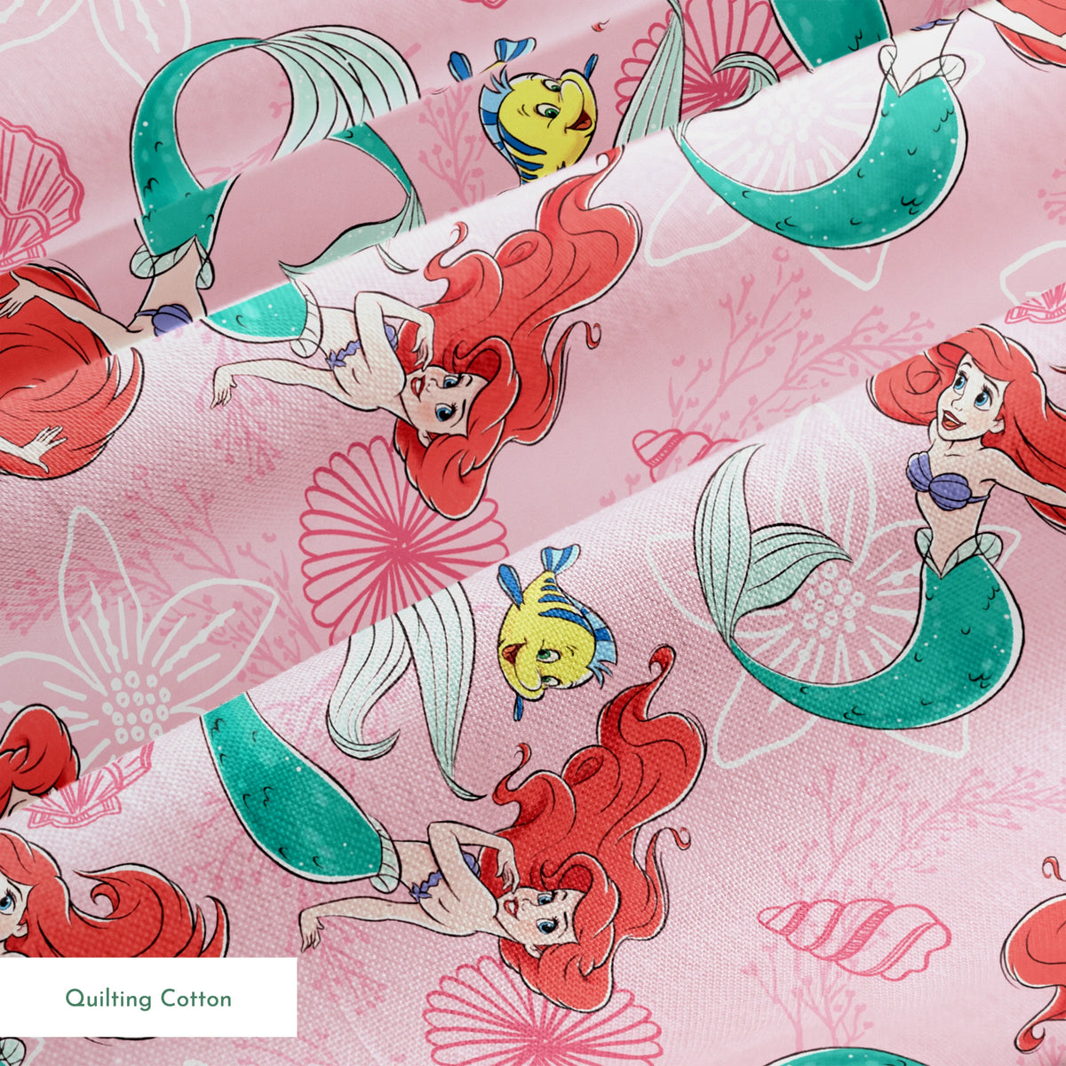 Illustrated pattern of mermaids with red hair and green tails swimming with yellow fish on pink seashell background springs quiltingcotton texture
