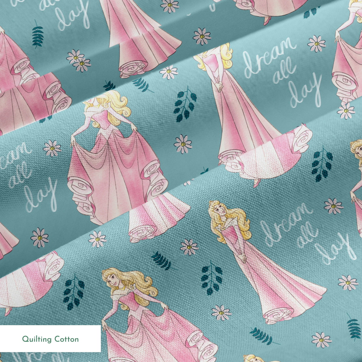 Sleeping Beauty pattern with "dream all day" text on teal background with floral elements springs quiltingcotton texture
