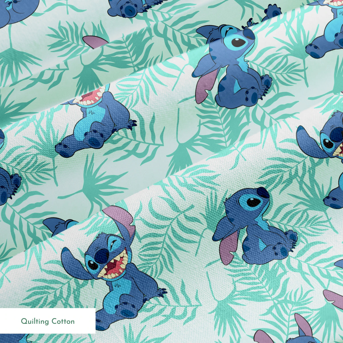 Blue cartoon alien character Stitch in various playful poses against mint green tropical leaf pattern background springs quiltingcotton texture