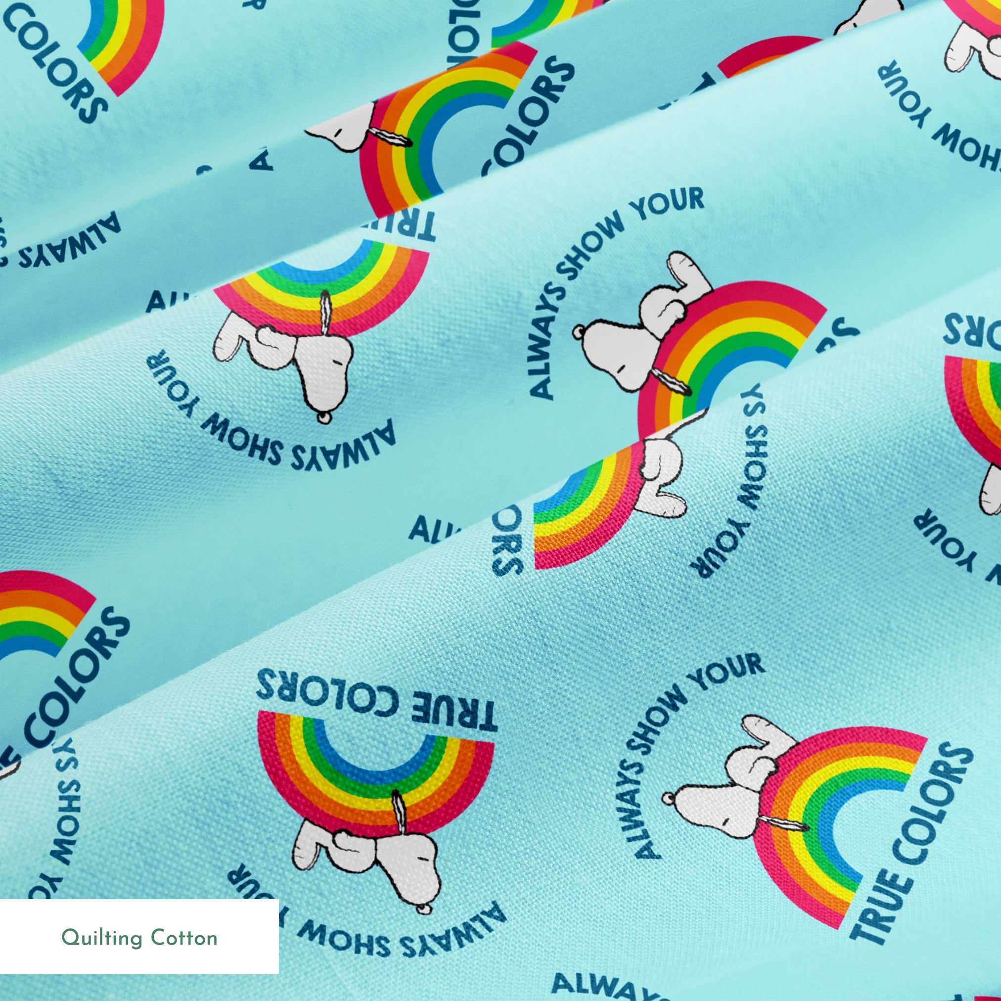 Rainbow Snoopy pattern on light blue background with white clouds and "TRUE COLORS" and "ALWAYS SHOW YOUR" text repeated throughout design springs quiltingcotton texture