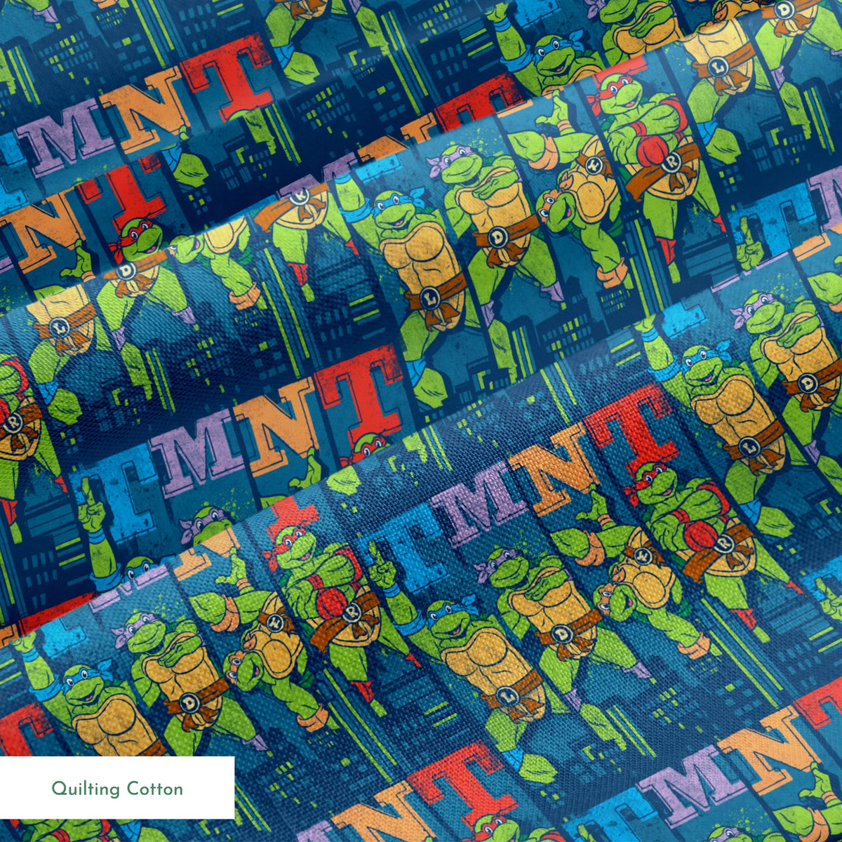Colorful Teenage Mutant Ninja Turtles cartoon pattern with characters and "TMNT" text on blue cityscape background springs quiltingcotton texture