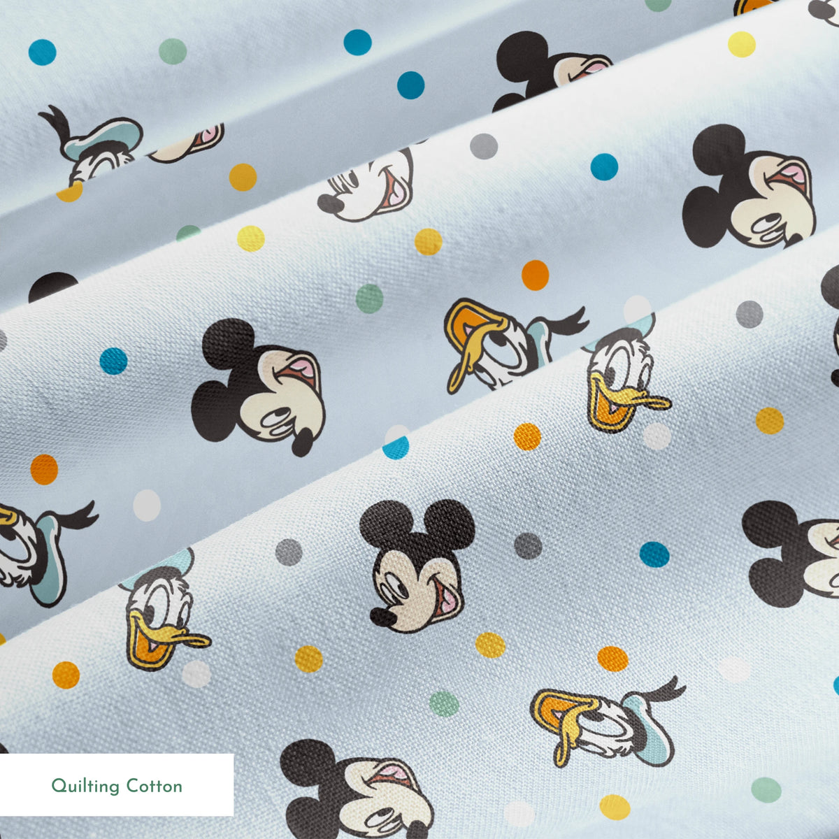 Disney character pattern with Mickey Mouse and Donald Duck heads scattered on light blue background with colorful polka dots springs quiltingcotton texture