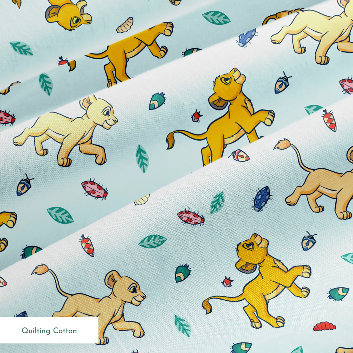 Lion cubs playing on light blue background with colorful leaves and plant elements scattered throughout springs quiltingcotton texture