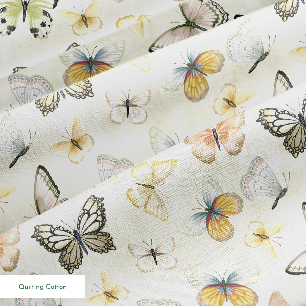 Hand-illustrated pastel butterflies in pink, blue, yellow, and sage on a cream background in a botanical-style Nicole Tamarin design. springs quiltingcotton texture