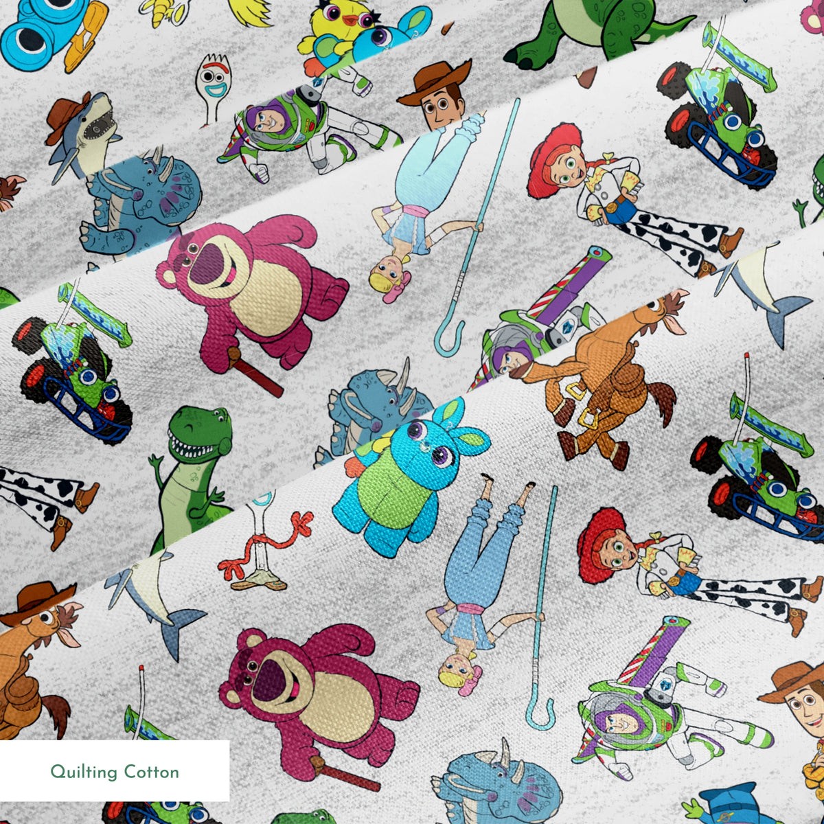 Colorful pattern of various animated Toy Story characters on a light speckled background springs quiltingcotton texture