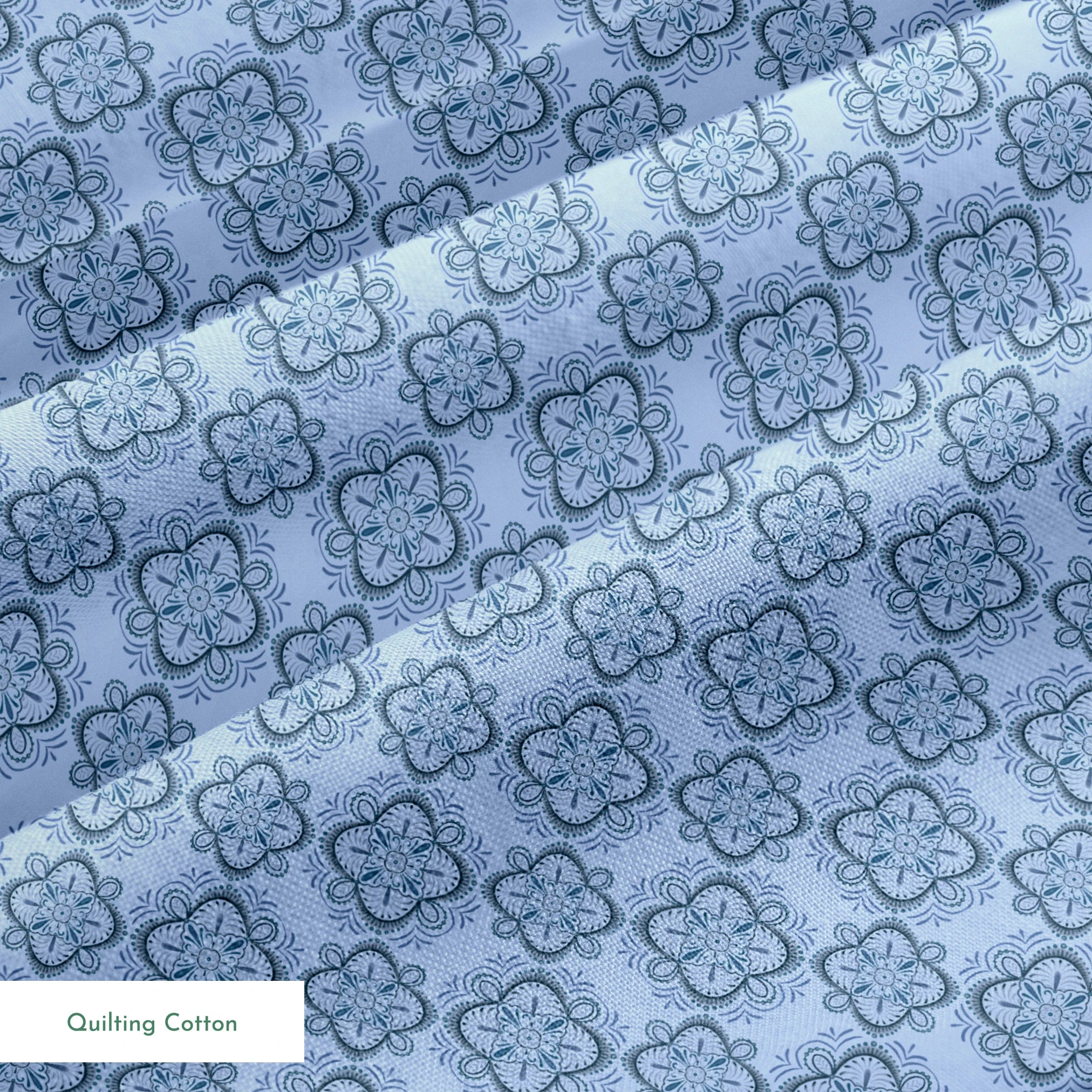 Symmetrical floral mandala pattern in layered blue tones with hand-drawn botanical details, designed by Nicole Tamarin. springs quiltingcotton texture