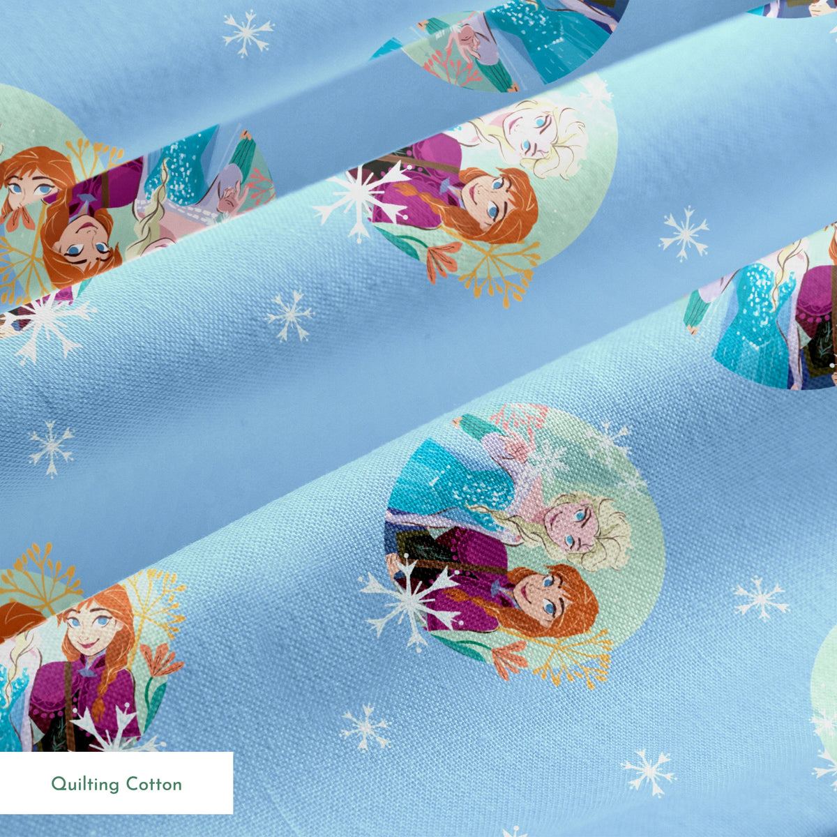 Light blue background with repeating circular motifs of "Frozen" characters and snowflakes in a decorative pattern springs quiltingcotton texture