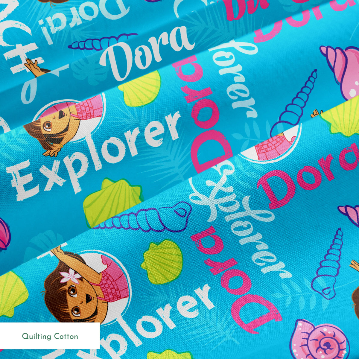 Bright blue pattern featuring Dora the Explorer cartoon character with seashells and "Beach Explorer" text springs quiltingcotton texture