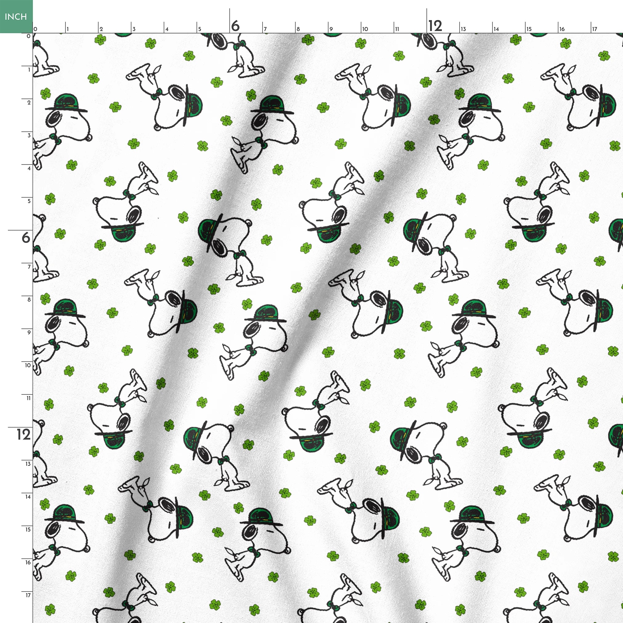 Cartoon Snoopy wearing green hat with shamrocks scattered across white background springs ruler 18x18