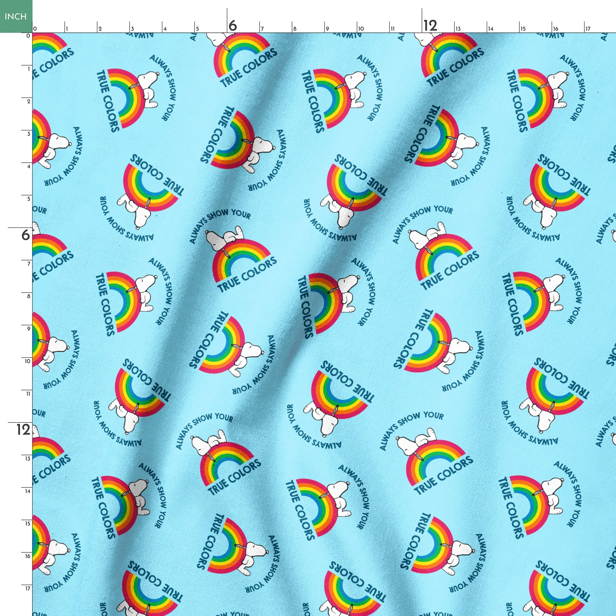 Rainbow Snoopy pattern on light blue background with white clouds and "TRUE COLORS" and "ALWAYS SHOW YOUR" text repeated throughout design springs ruler 18x18
