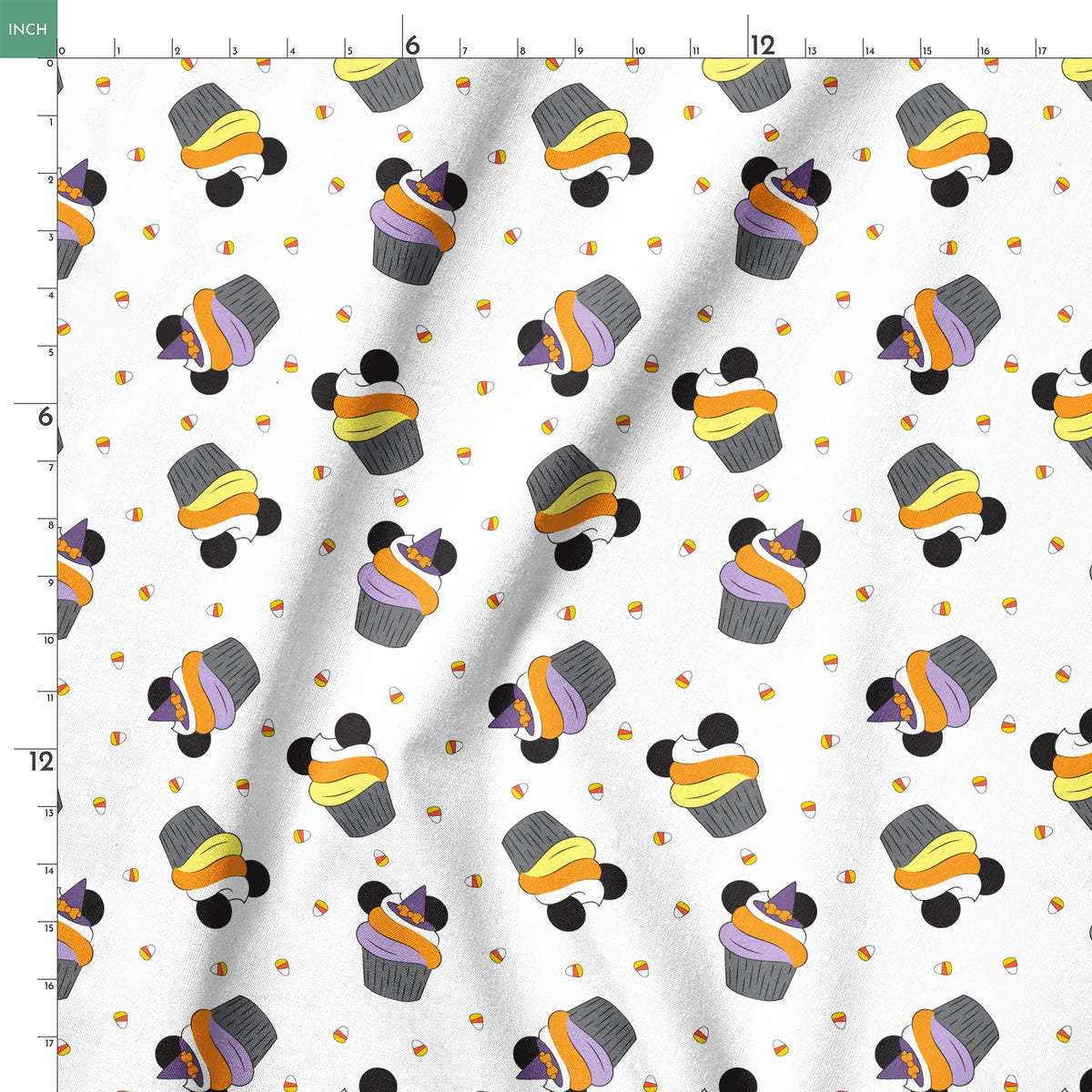Disney cupcakes with black circular elements and colorful frosting in orange, yellow, and purple on a white background. springs ruler 18x18
