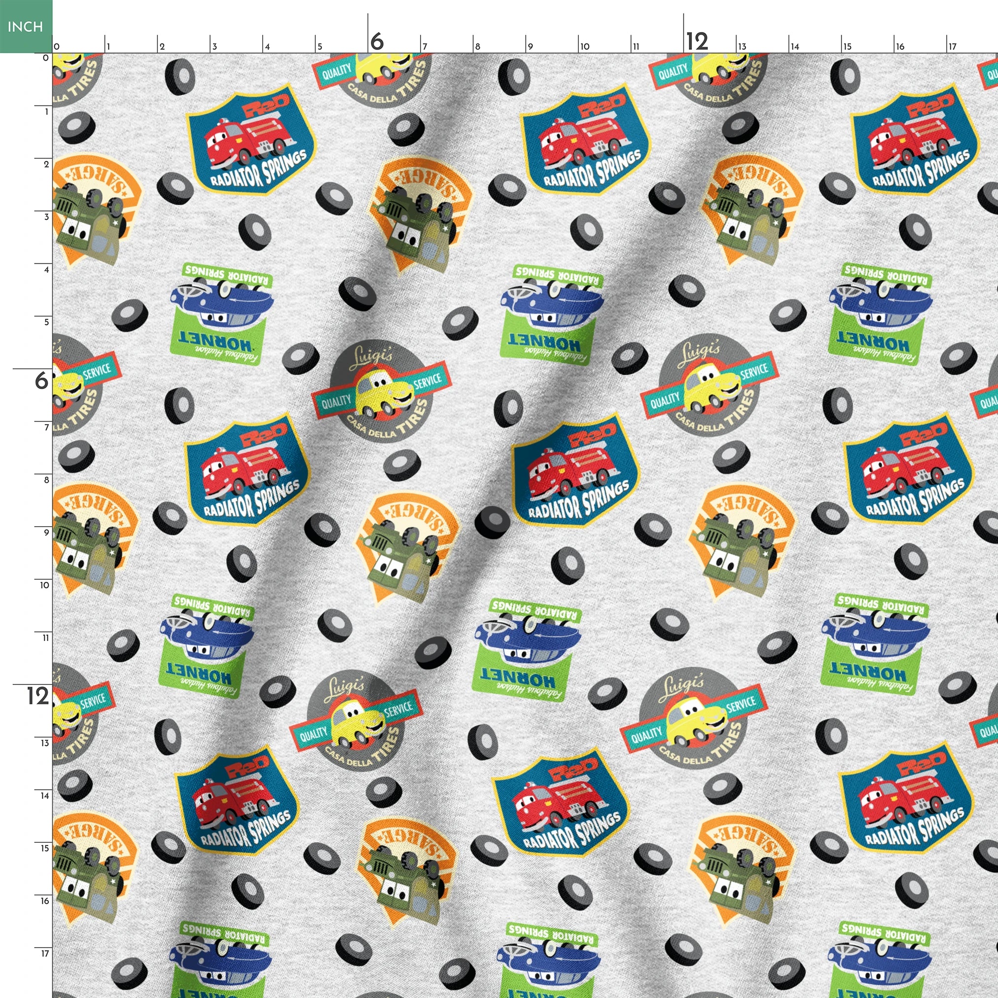 Cartoon vehicle characters on gray fabric with badges for Radiator Springs, Luigi's, and Sarge's springs ruler 18x18
