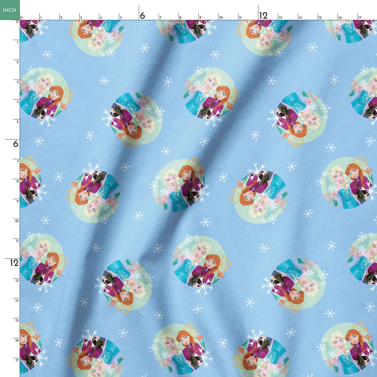 Light blue background with repeating circular motifs of "Frozen" characters and snowflakes in a decorative pattern springs ruler 18x18