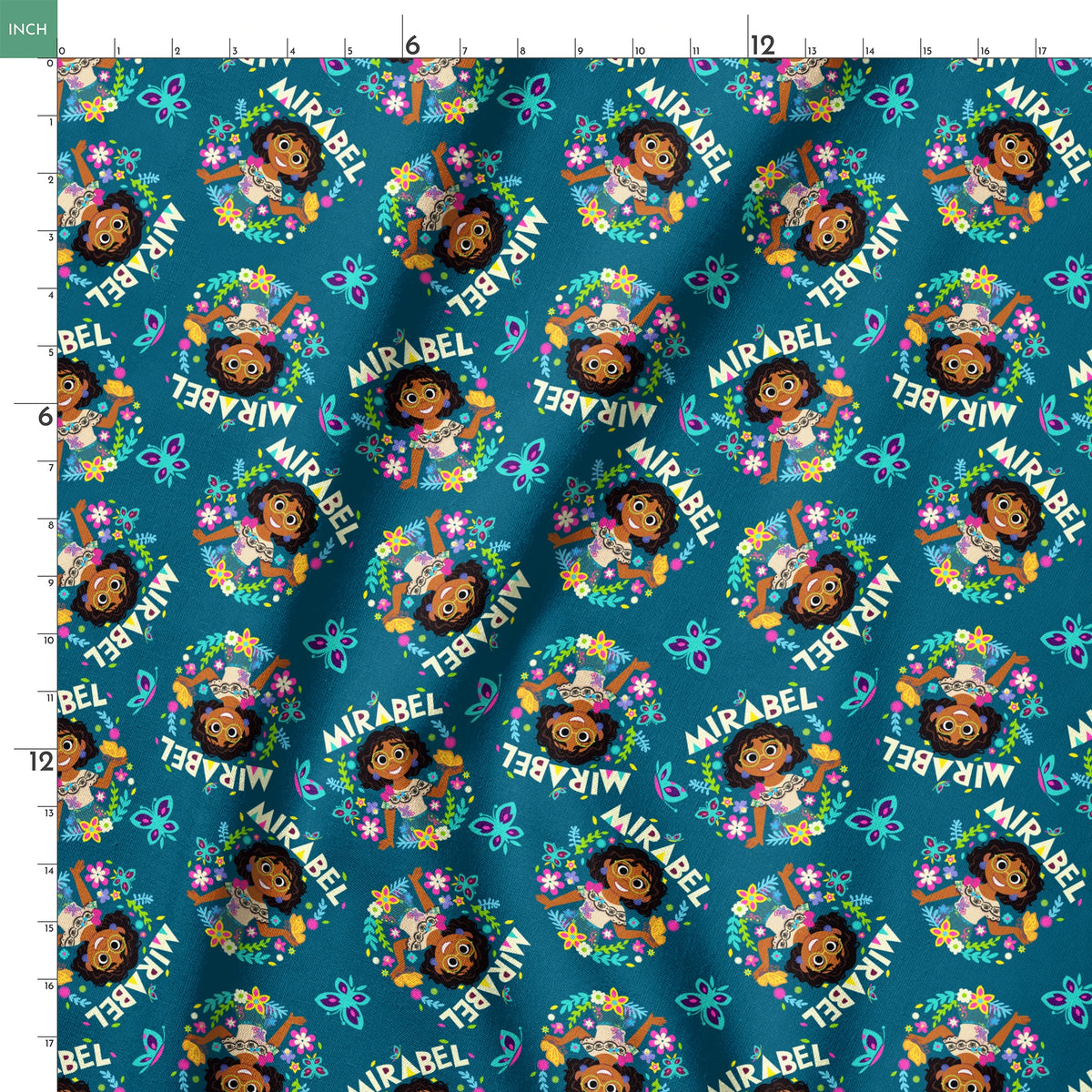 Colorful cartoon pattern on teal background featuring characters, butterflies, flowers, and "Mirabel" text in repeating design springs ruler 18x18