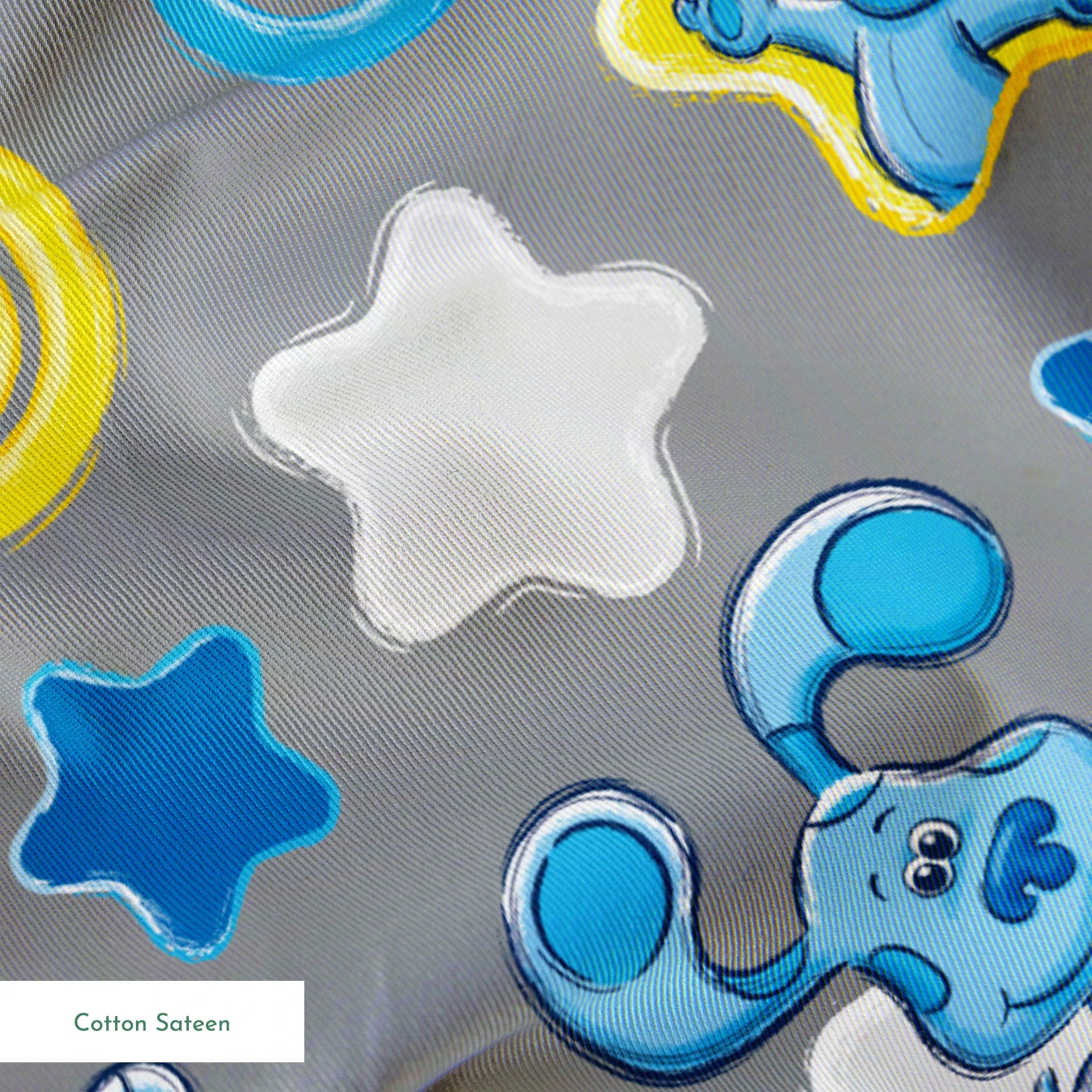 Blue cartoon elephants with stars, swirls, and clouds pattern on gray background springs sateen texture