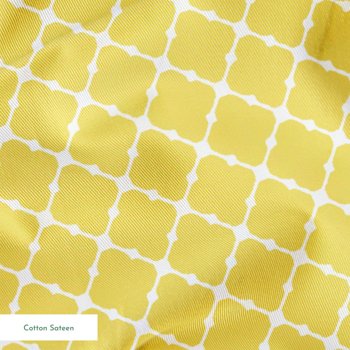 Yellow quatrefoil pattern on white background with Moroccan tile inspired design springs sateen texture