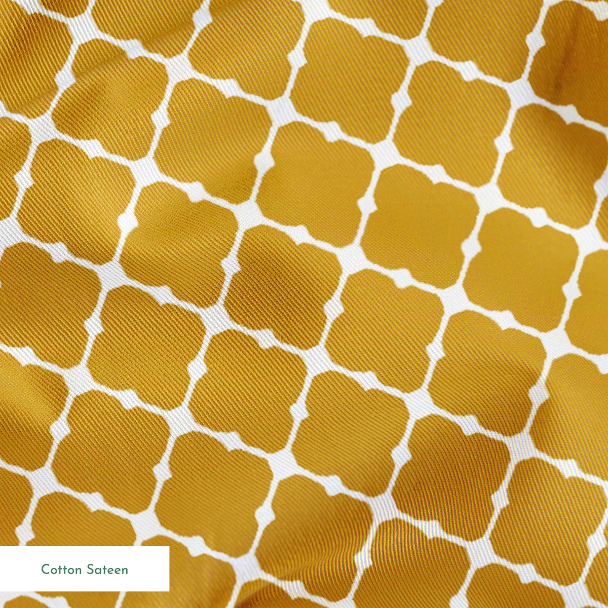 Gold quatrefoil pattern on white background, forming a geometric Moroccan-style lattice design springs sateen texture