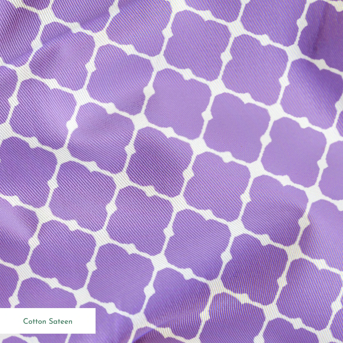 Purple quatrefoil pattern with white lattice grid on lavender background springs sateen texture