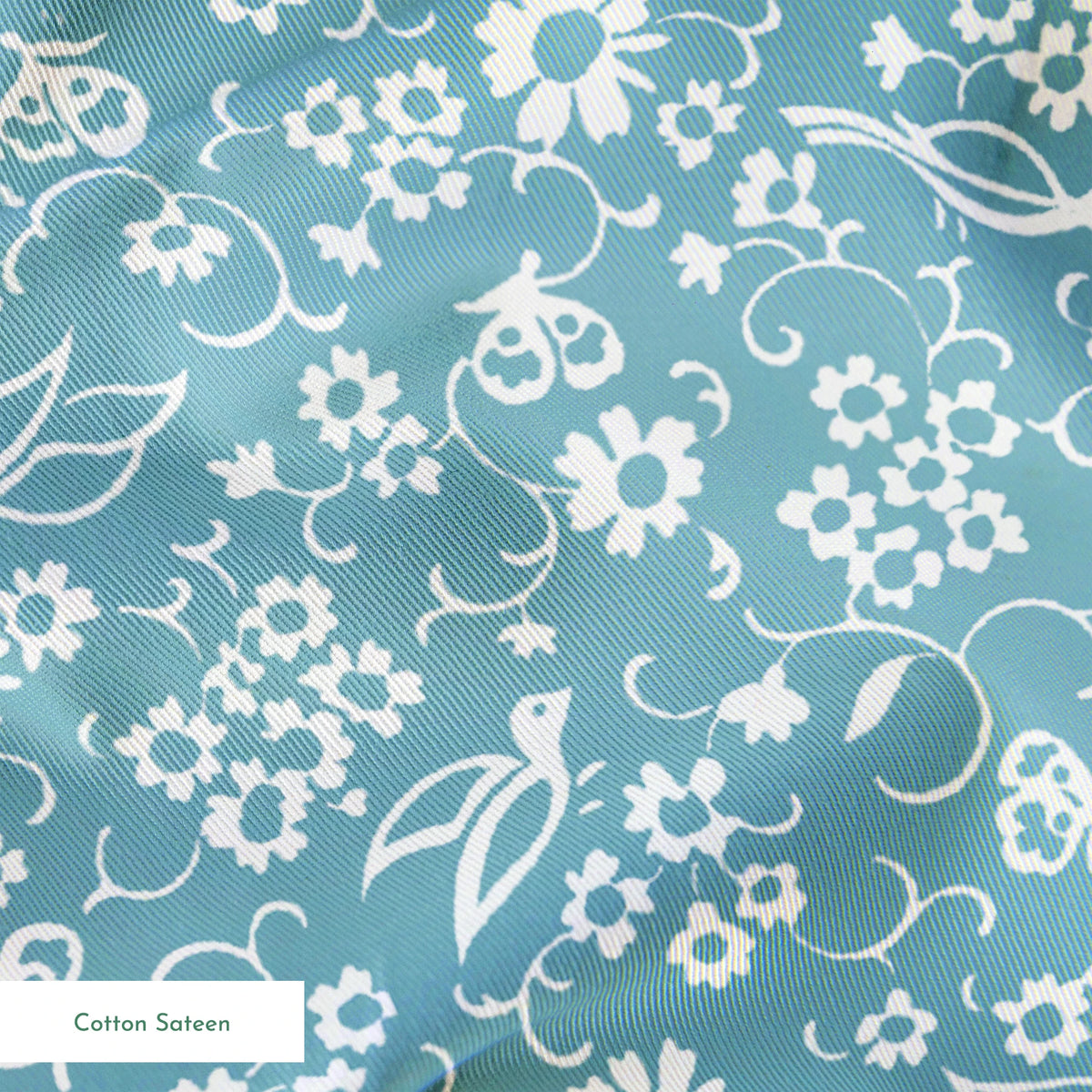 White vintage-style bird and floral silhouettes on a dusty blue background. springs sateen texture