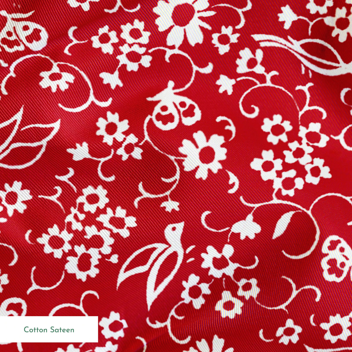 White floral and bird silhouette pattern on a bright red background. springs sateen texture