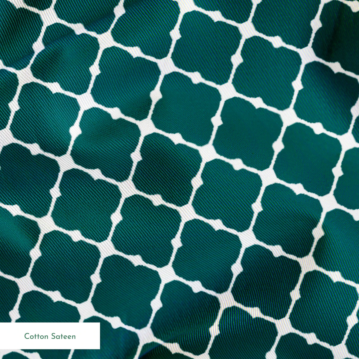 Dark teal quatrefoil pattern with white lattice outlines on a geometric background springs sateen texture