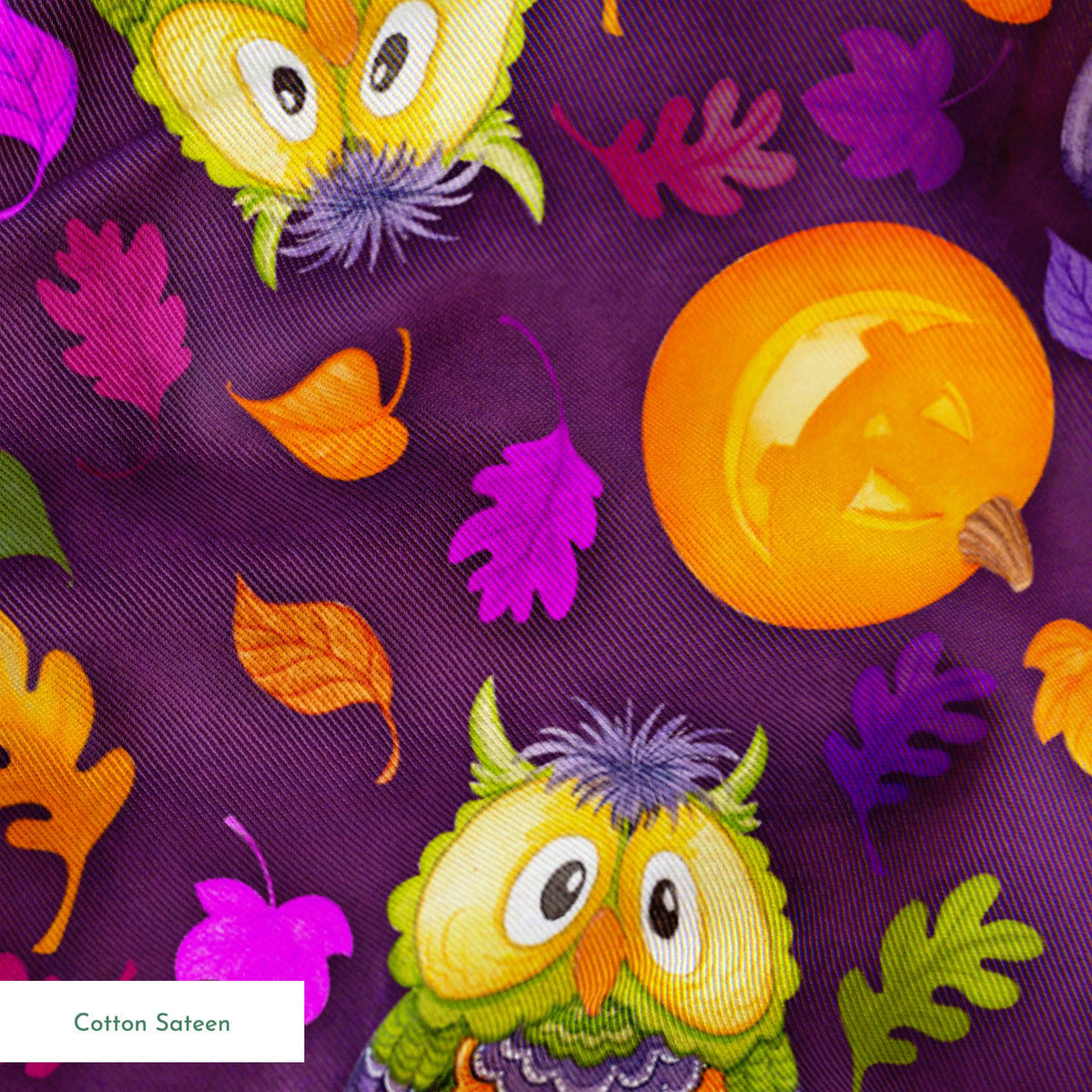 Halloween fabric by Nicole Tamarin featuring cartoon owls in costume, jack-o’-lanterns, and colorful fall leaves on a purple background. springs sateen texture