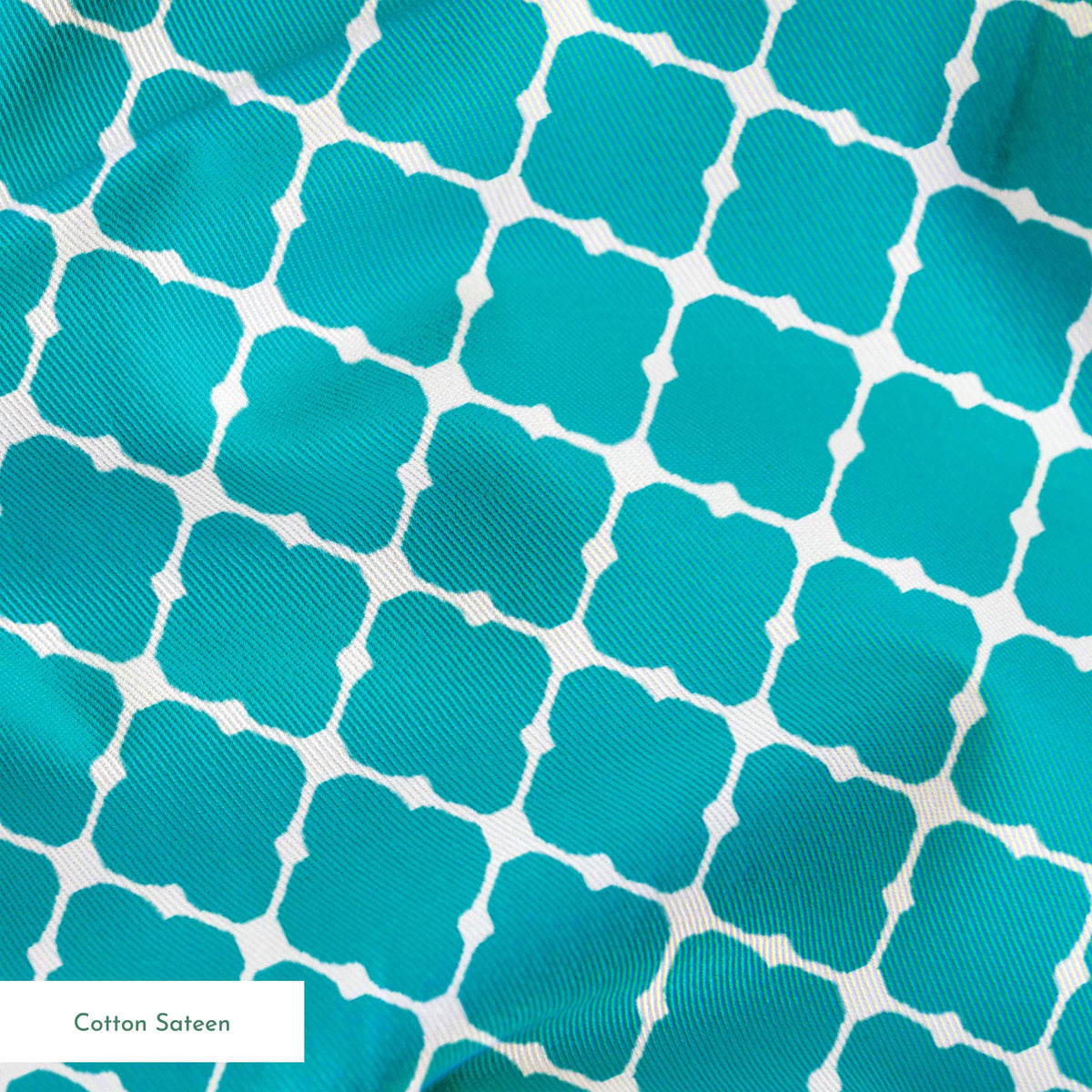 Turquoise and white quatrefoil pattern with Moroccan-inspired geometric design springs sateen texture