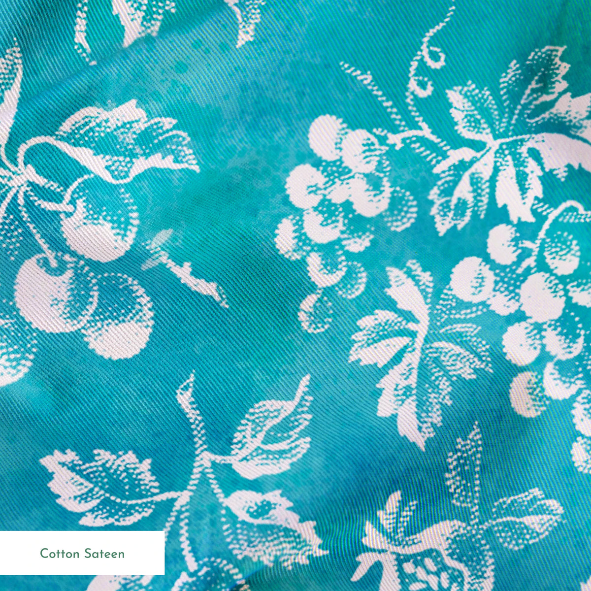 Teal background with white vintage fruit pattern featuring cherries, grapes, and pears springs sateen texture