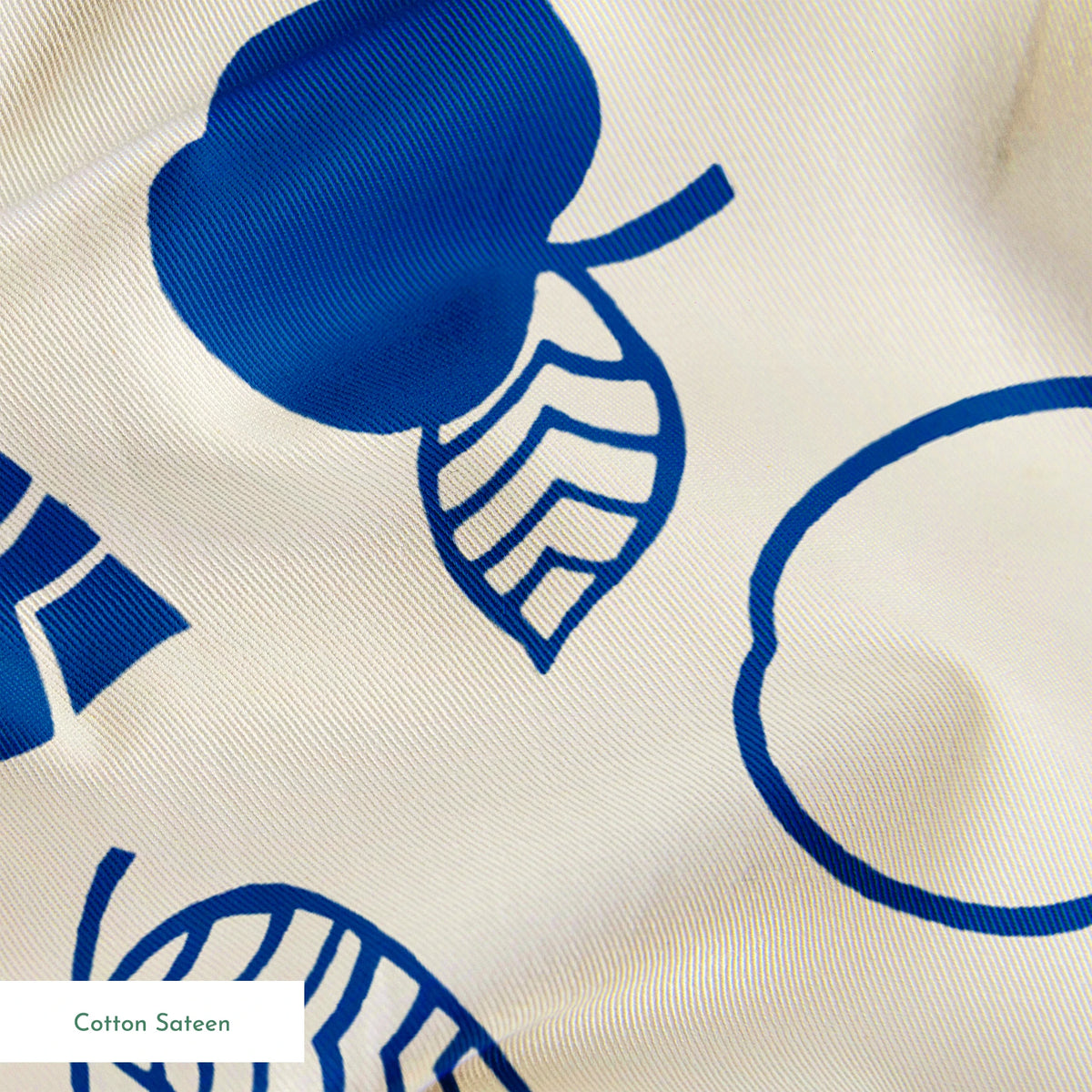 Blue apple illustrations and leaf outlines arranged in a scattered pattern on cream background. springs sateen texture