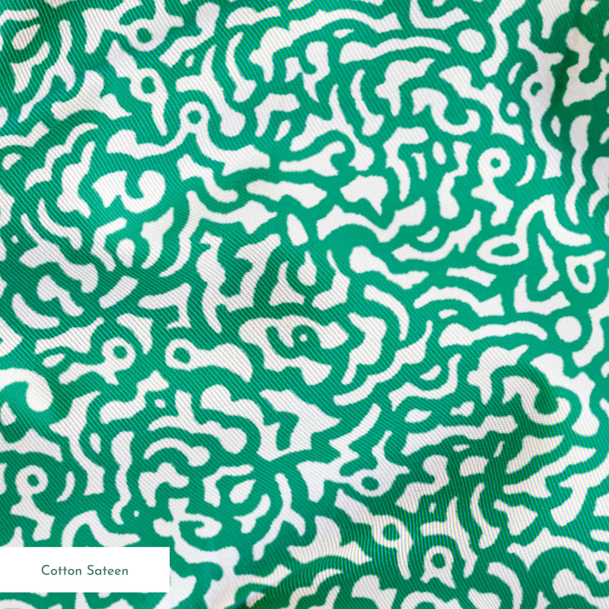 Abstract green and white pattern with organic swirling lines resembling coral or brain-like formations springs sateen texture