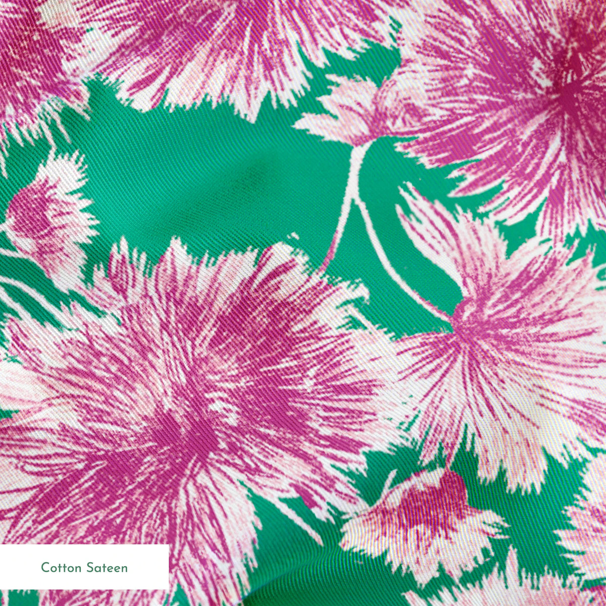 Pink and purple carnation flowers scattered on a green background in a repeating floral pattern springs sateen texture