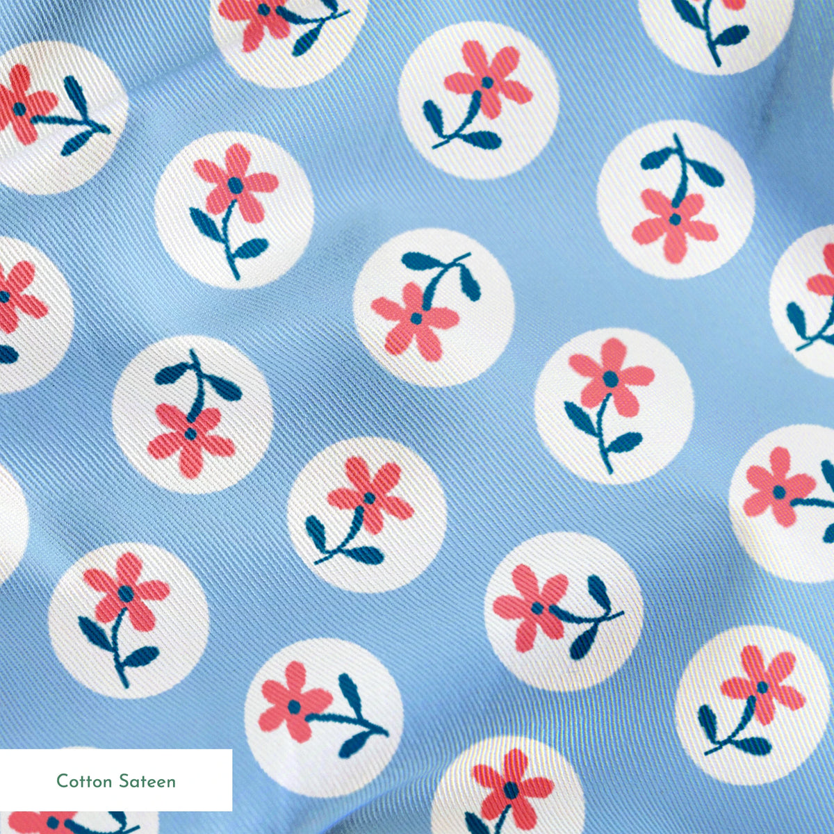 Pink flowers with blue-green stems in white circles on pale blue background, repeating pattern springs sateen texture