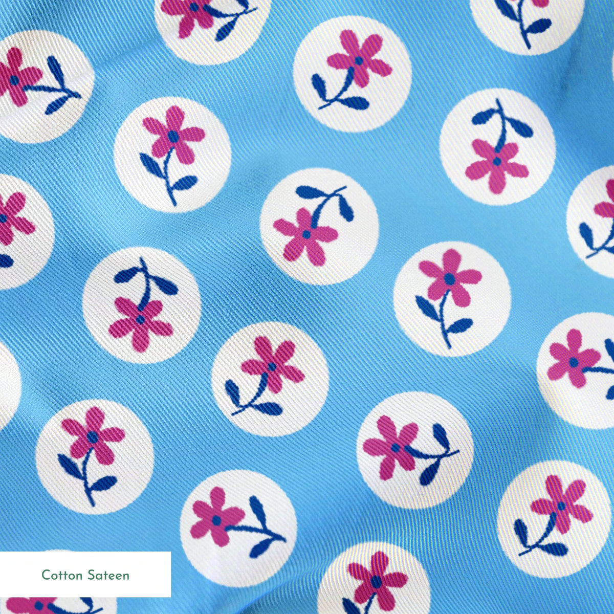 Purple flowers with blue stems inside white circles on light blue background pattern springs sateen texture