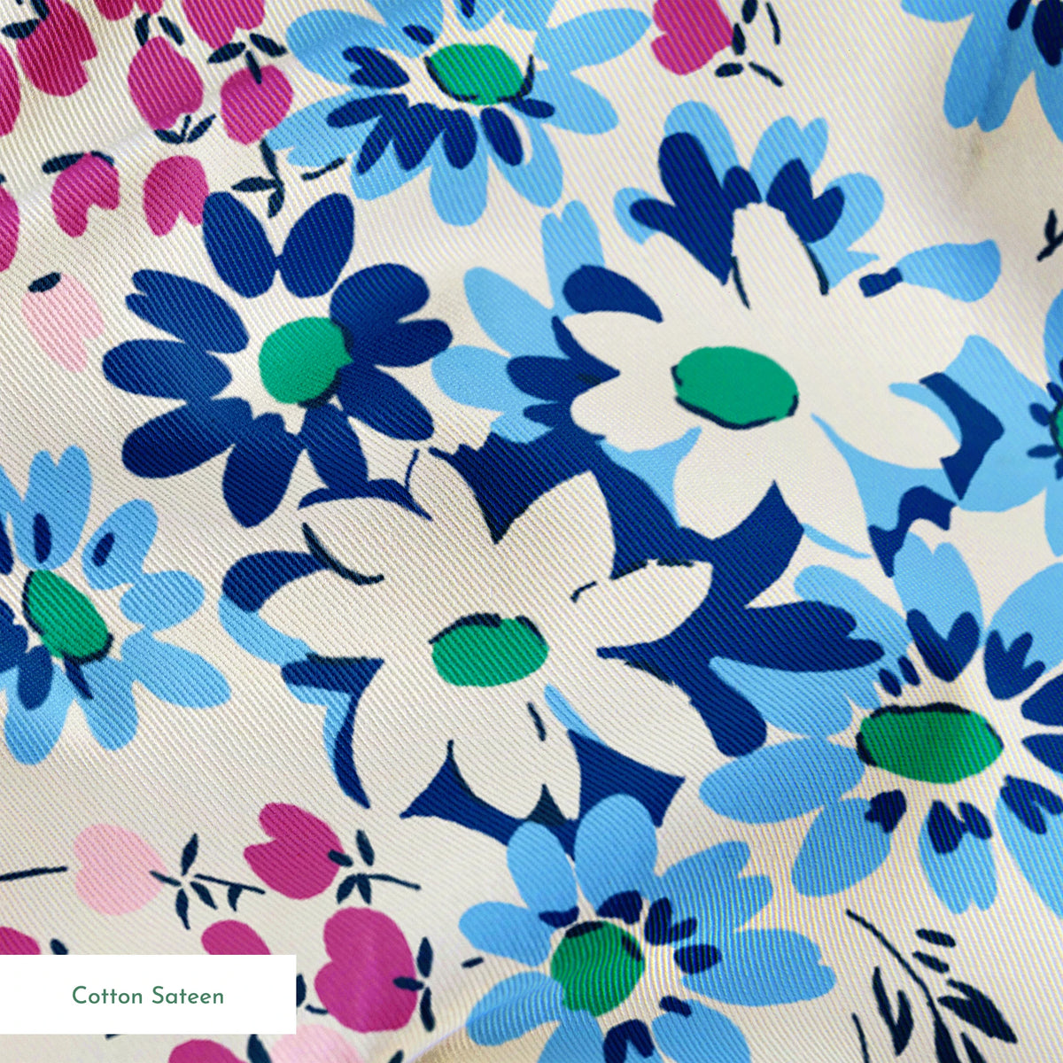 Floral pattern with blue, navy, and white daisies alongside small magenta berries on cream background springs sateen texture