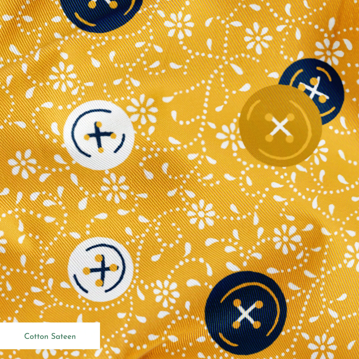 Circular buttons with cross symbols in gold, navy, and white scattered on a gold floral background springs sateen texture