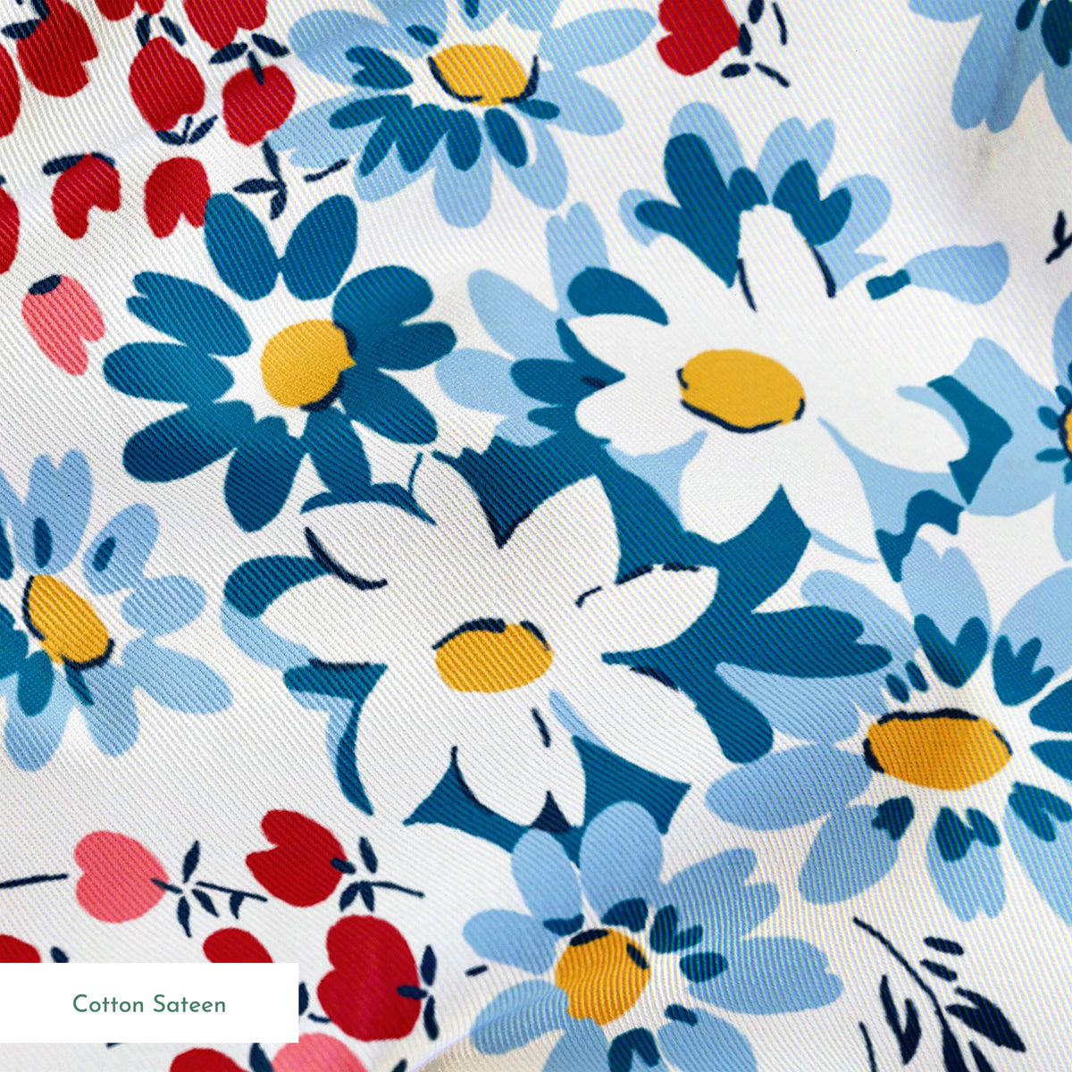 Blue and white daisies with small red berries scattered across a light background in a floral pattern springs sateen texture