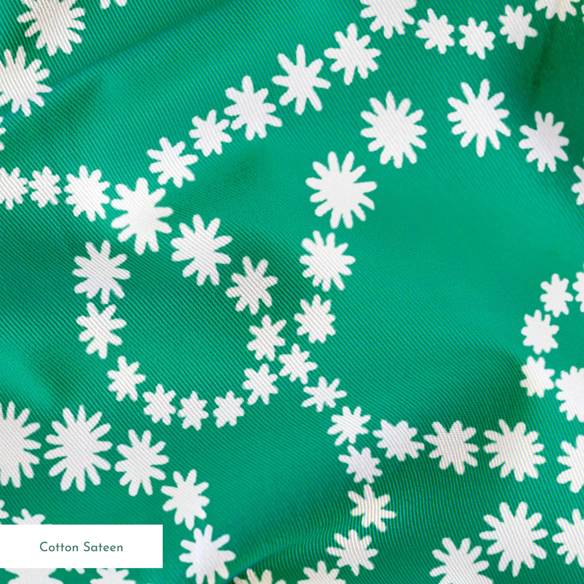 White dotted swirling patterns on green background forming abstract curving lines springs sateen texture