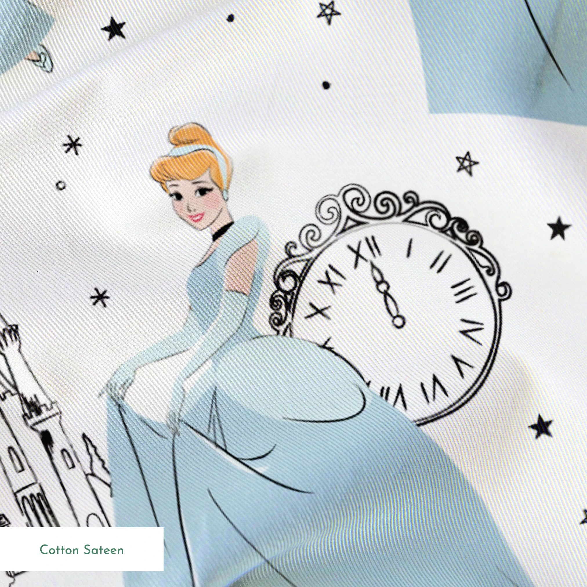 Whimsical pattern featuring cartoon princess in blue gown, clocks, castles, carriages and "Enchanting" text on white background springs sateen texture