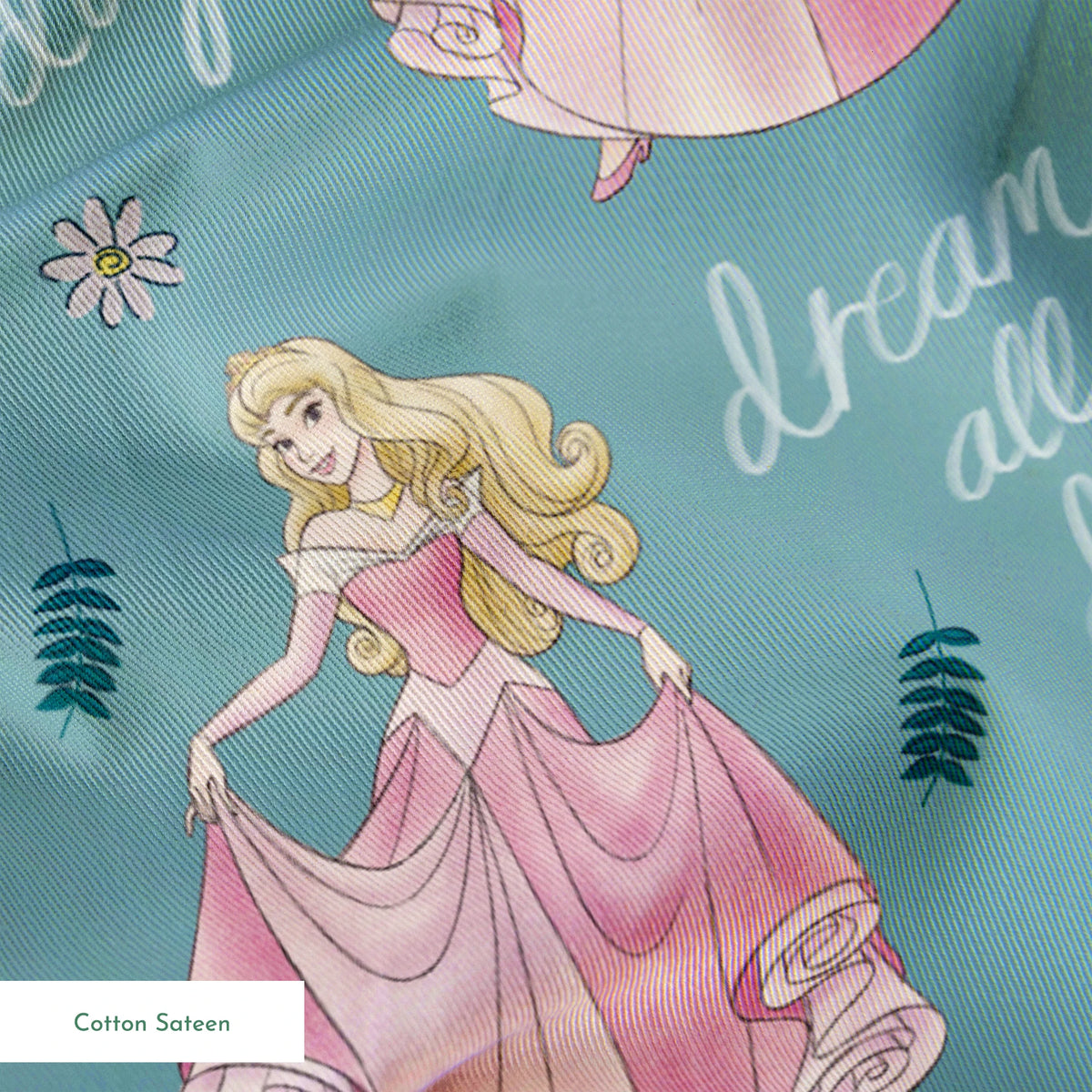 Sleeping Beauty pattern with "dream all day" text on teal background with floral elements springs sateen texture