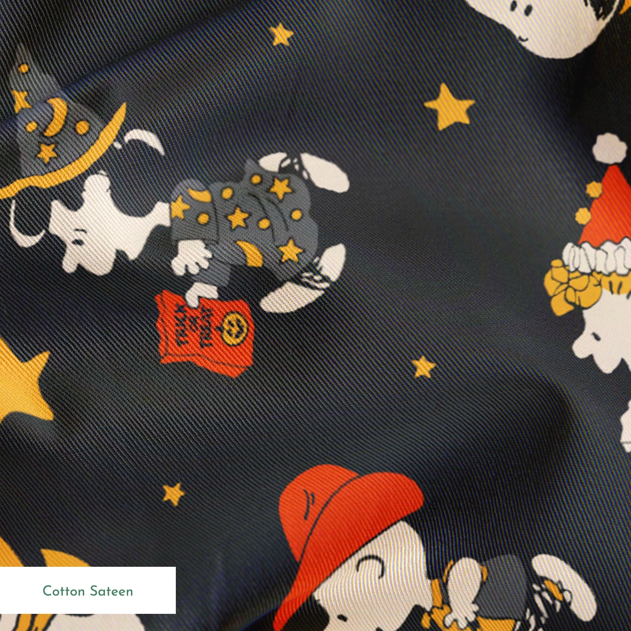Snoopy cartoon pattern on dark gray background with characters in Halloween costumes and golden stars springs sateen texture
