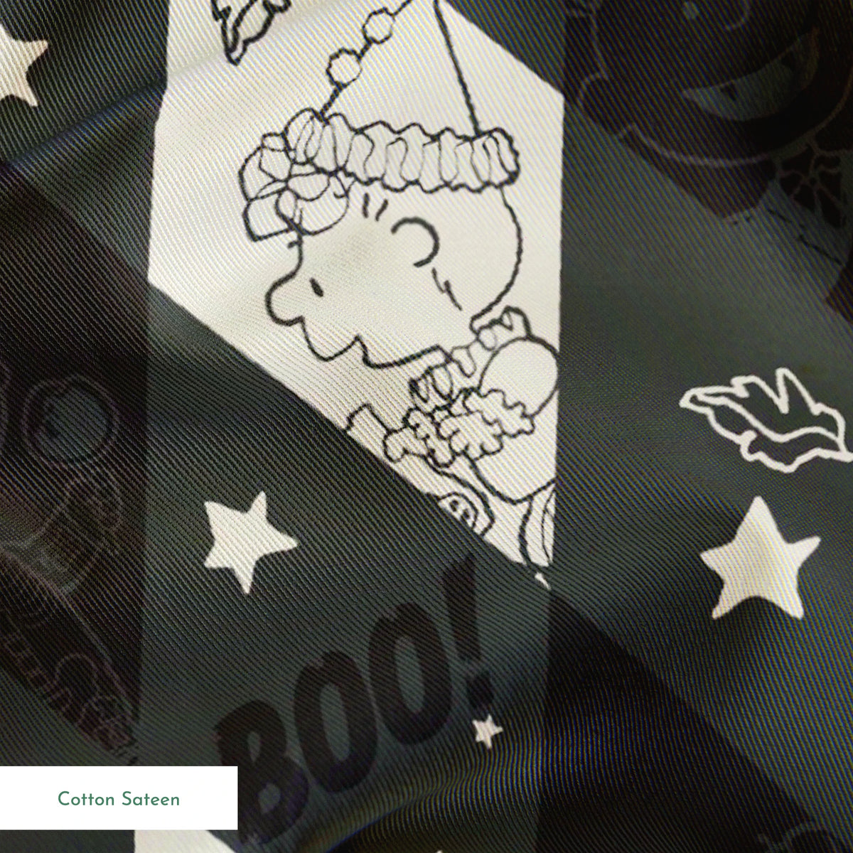 Diamond pattern with Peanuts characters and Halloween motifs in black and cream, featuring spider webs, stars, and "BOO!" text. springs sateen texture