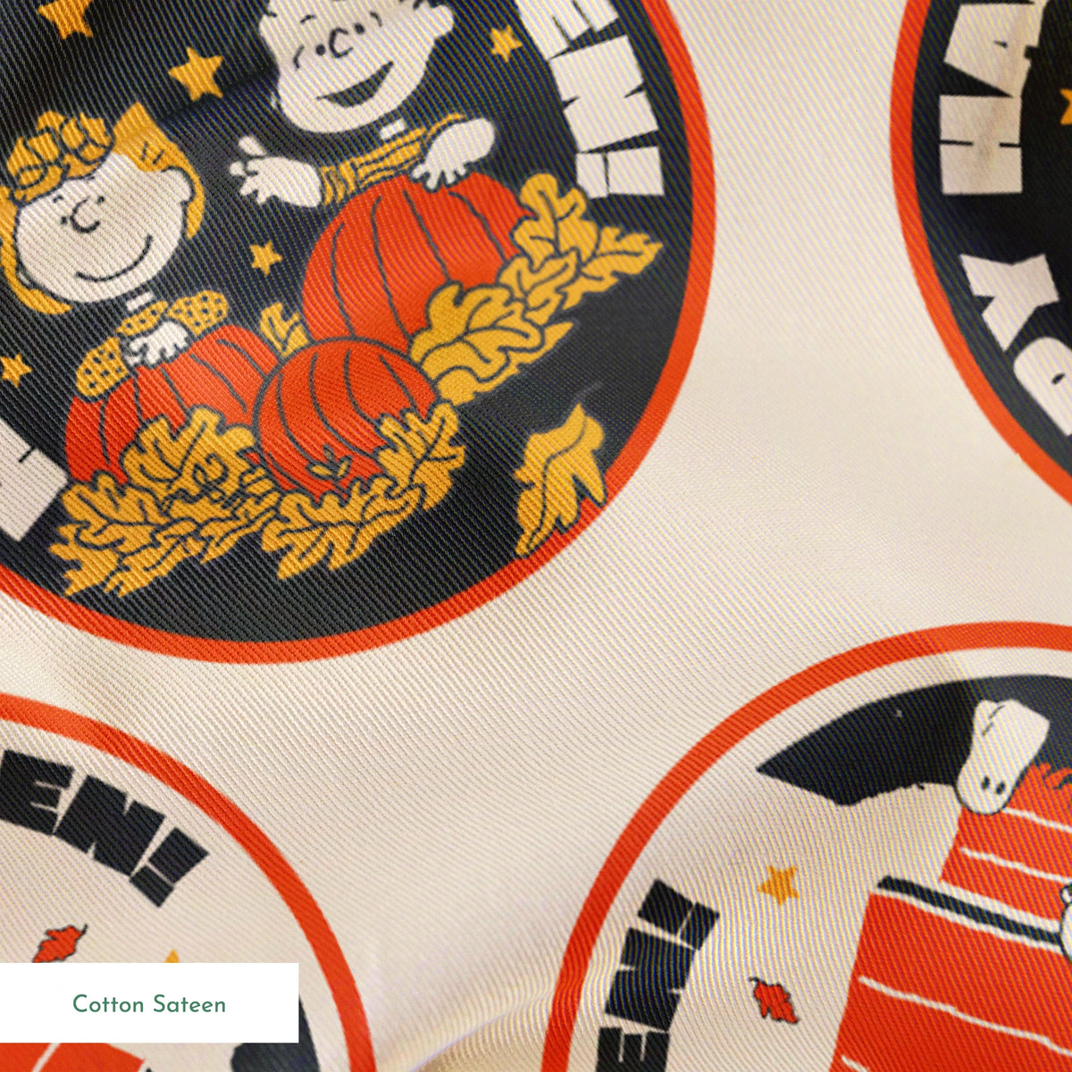 Peanuts Halloween pattern with circular badges featuring characters and "Happy Halloween" text on beige background springs sateen texture