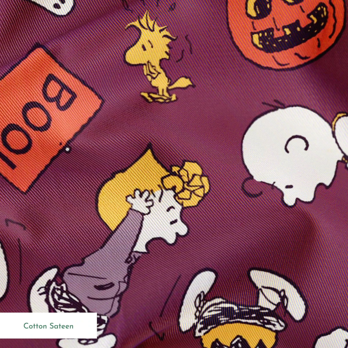 Snoopy and Woodstock Halloween pattern on purple background with pumpkins, ghosts, and "boo!" text springs sateen texture