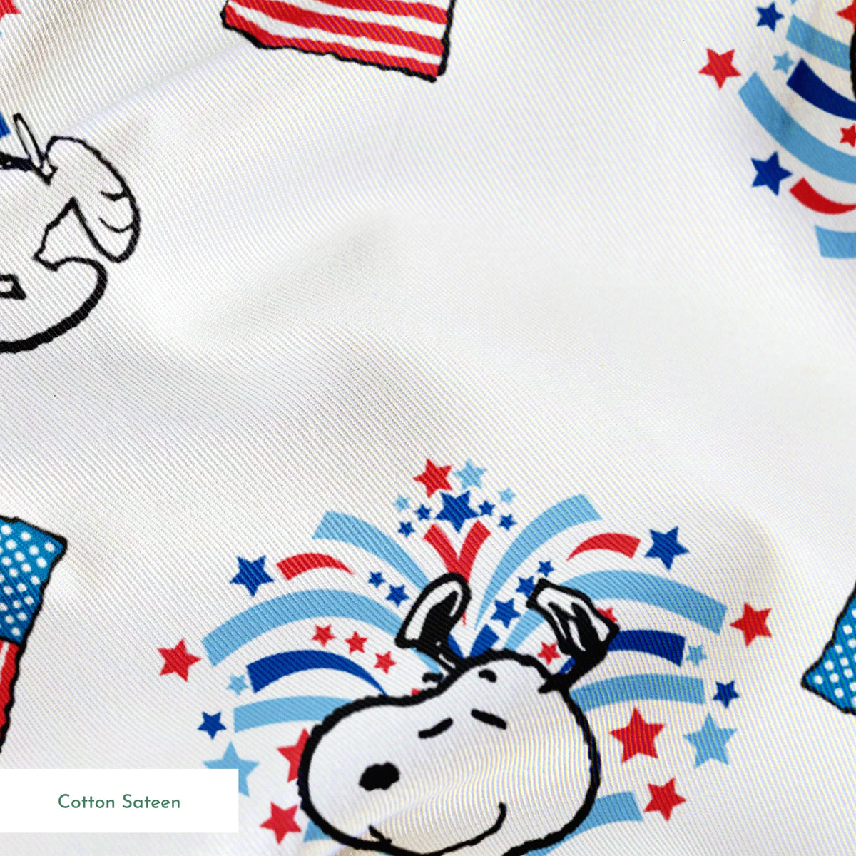 Snoopy with red and blue fireworks pattern alongside American flags on white background springs sateen texture