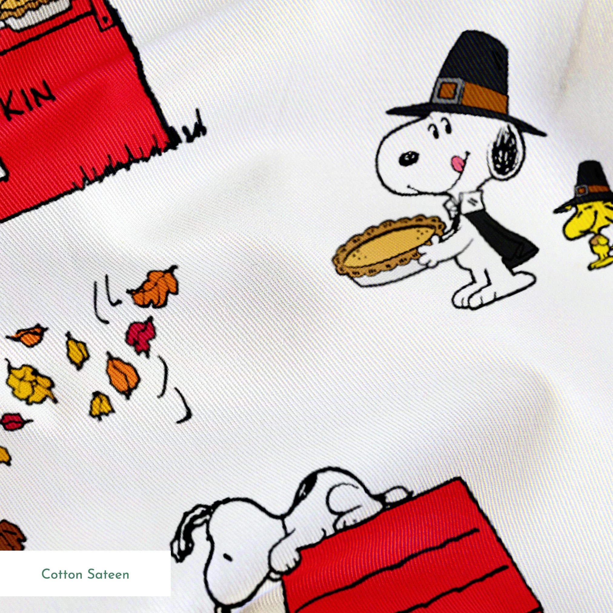 Peanuts Thanksgiving pattern with Snoopy, red booths, doghouses, and falling autumn leaves on white background springs sateen texture