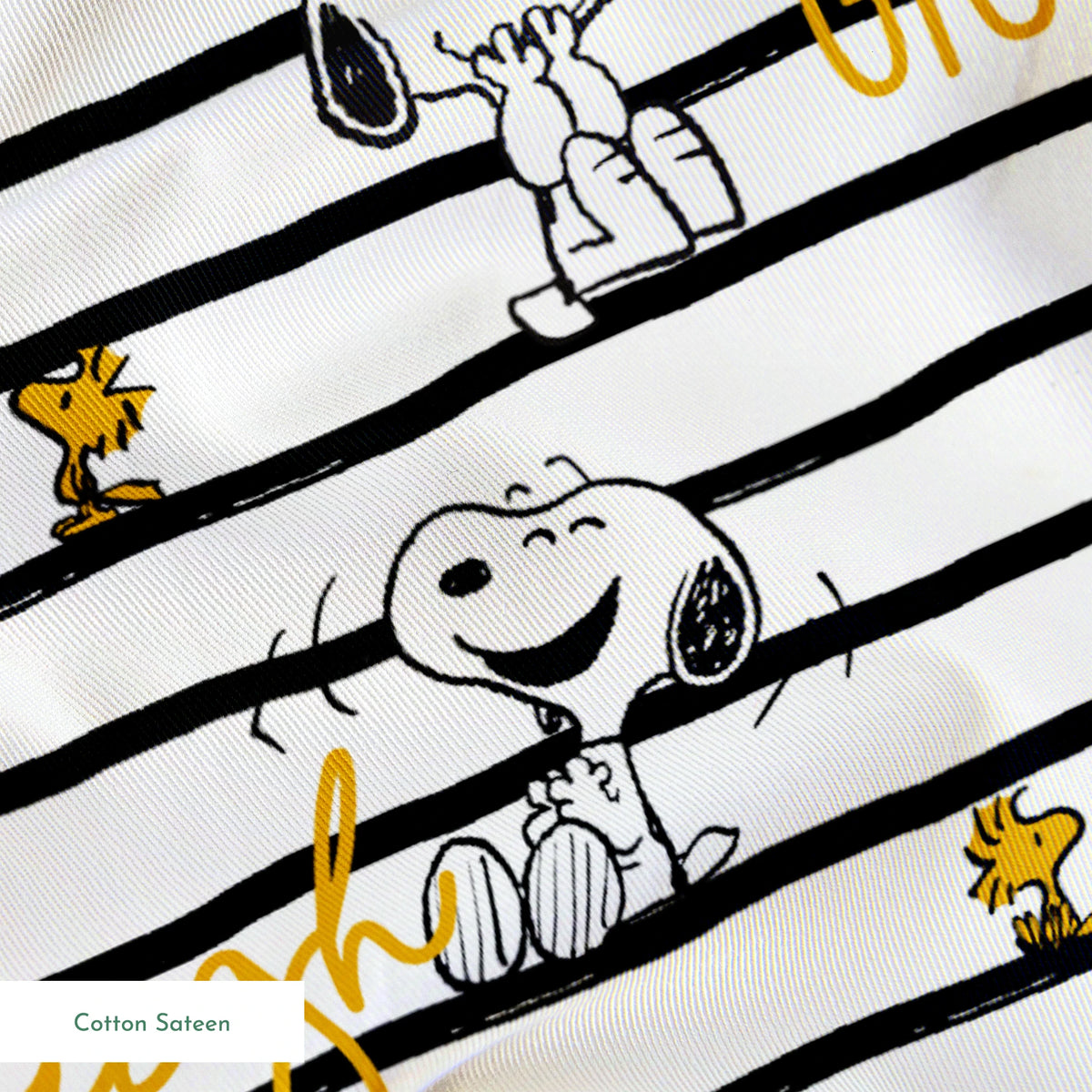 Black and white striped pattern with Snoopy and Woodstock, yellow text saying "giggle," "laugh," "smile springs sateen texture