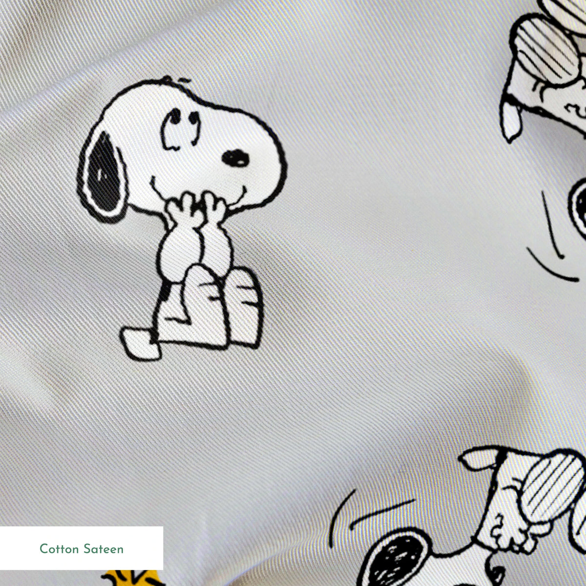 Pattern of Peanut's Snoopy and Woodstock on light gray background springs sateen texture