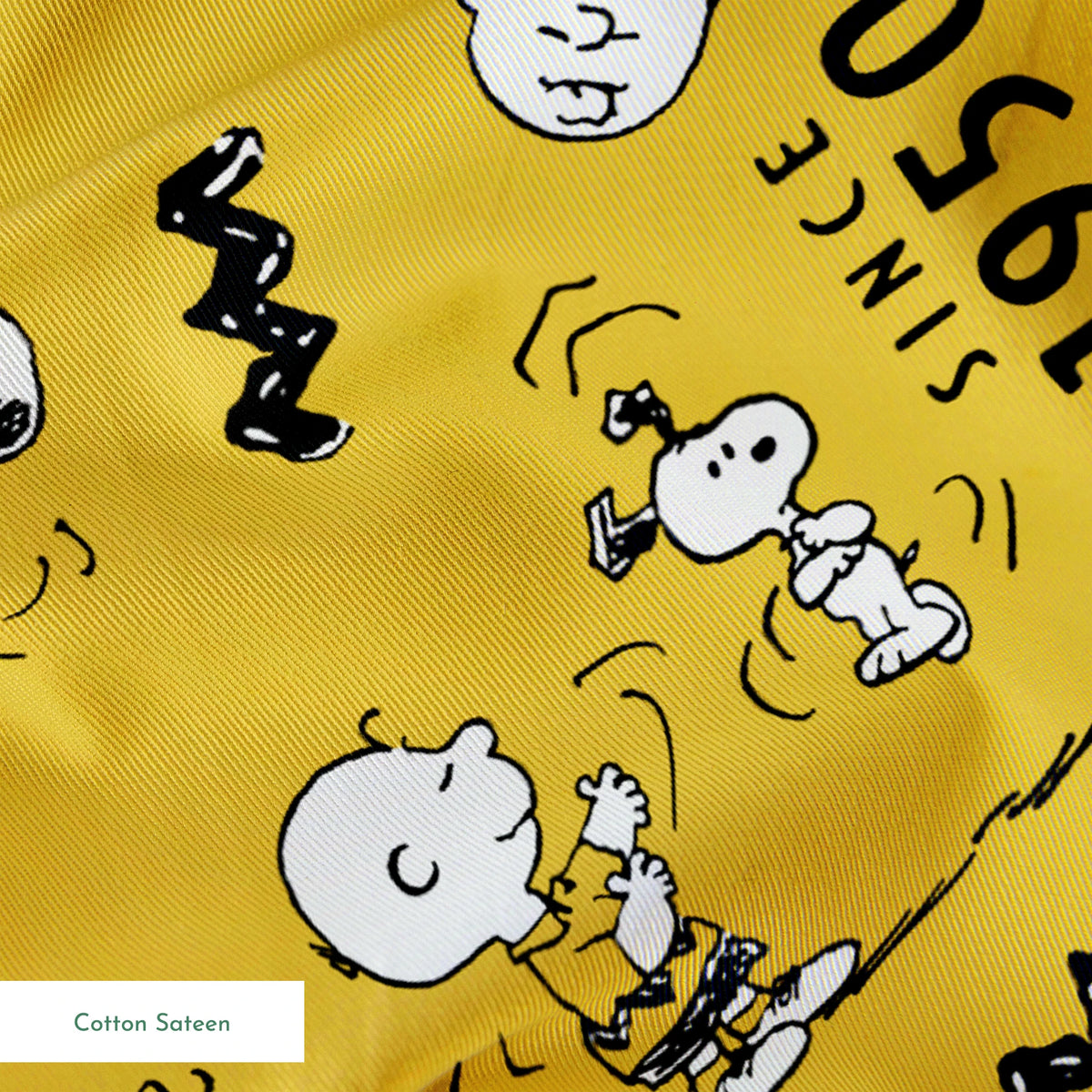 Peanuts cartoon pattern on yellow background with Snoopy and Charlie Brown, "Since 1950" text springs sateen texture