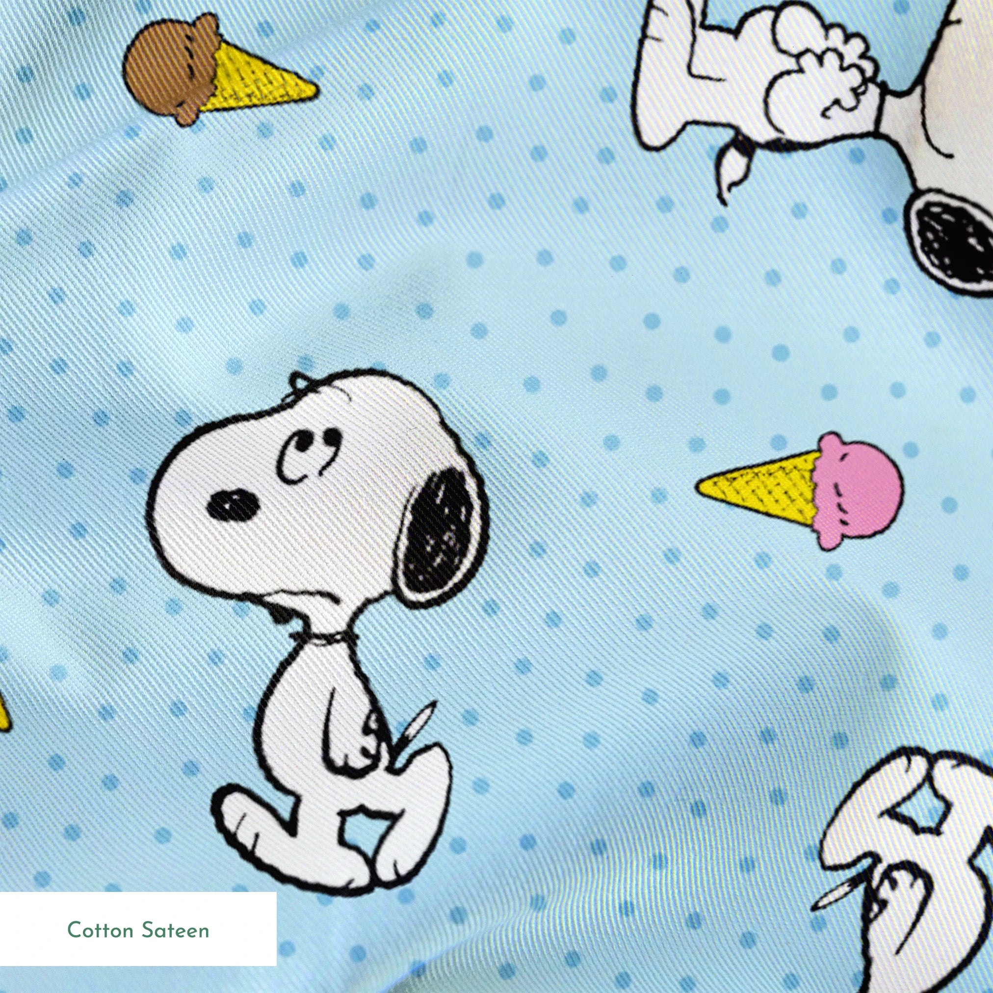 Snoopy pattern on light blue background with ice cream cones and small white dots springs sateen texture